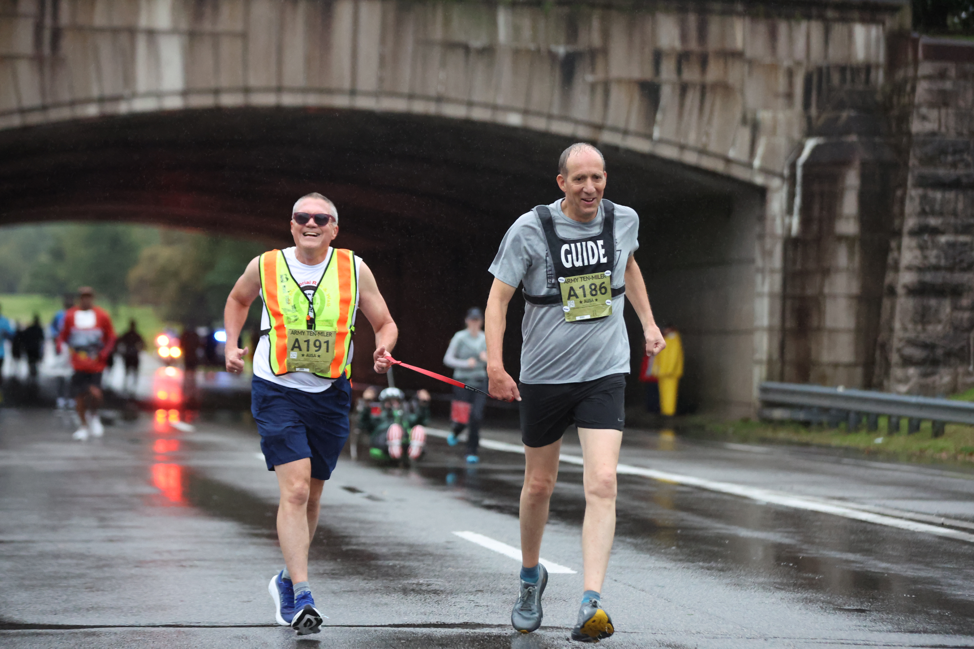 Two runners pass the bridge near mile 1 of the Army Ten-Miler on October 11, 2026.