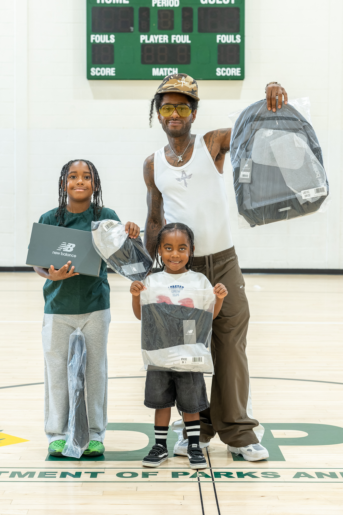 Attendees show off the backpack, shirt and shoes they carried out of the gym.