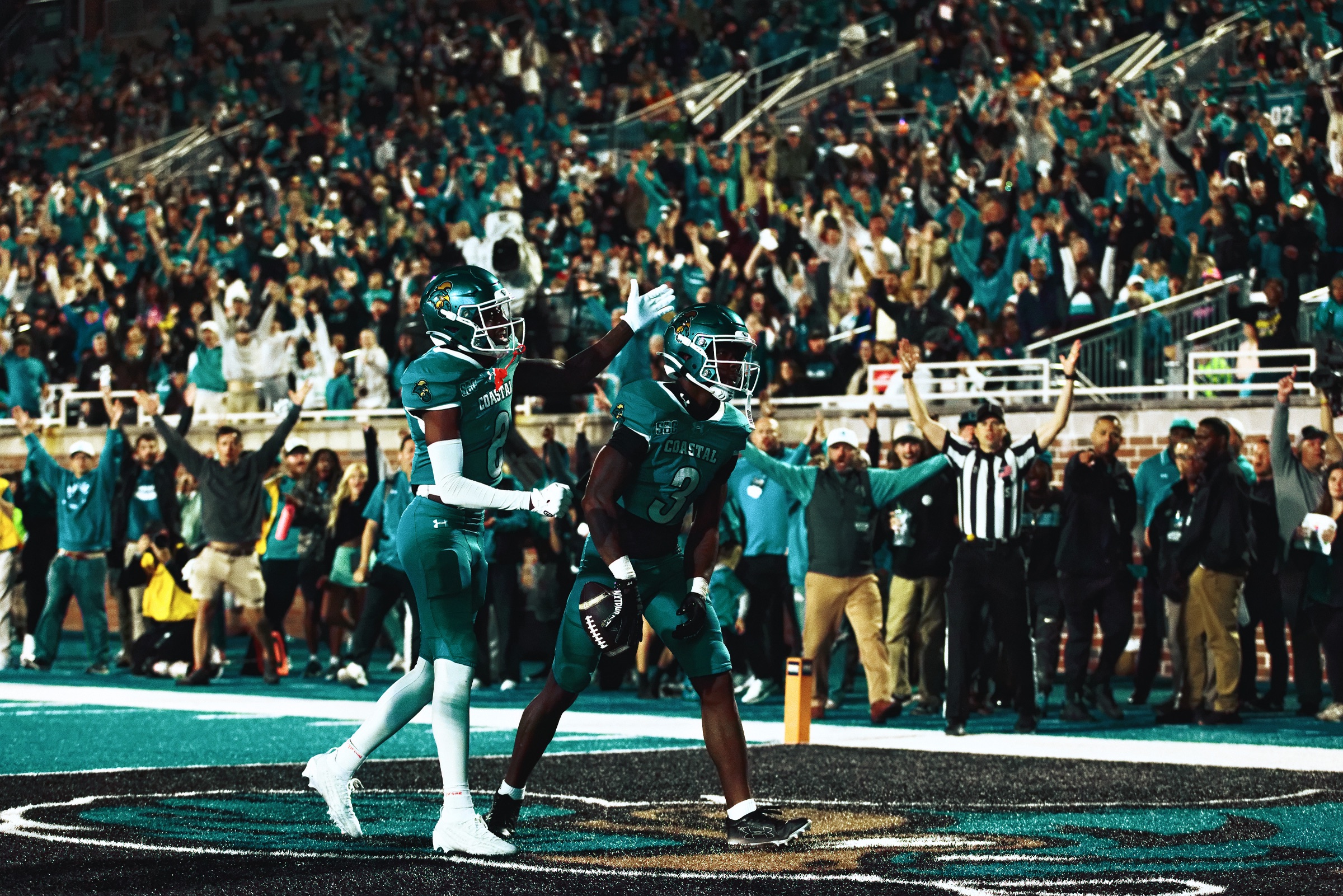 A Coastal Carolina receiver reaches for a catch against Liberty coverage at Brooks Stadium on Sept. 24, 2026.