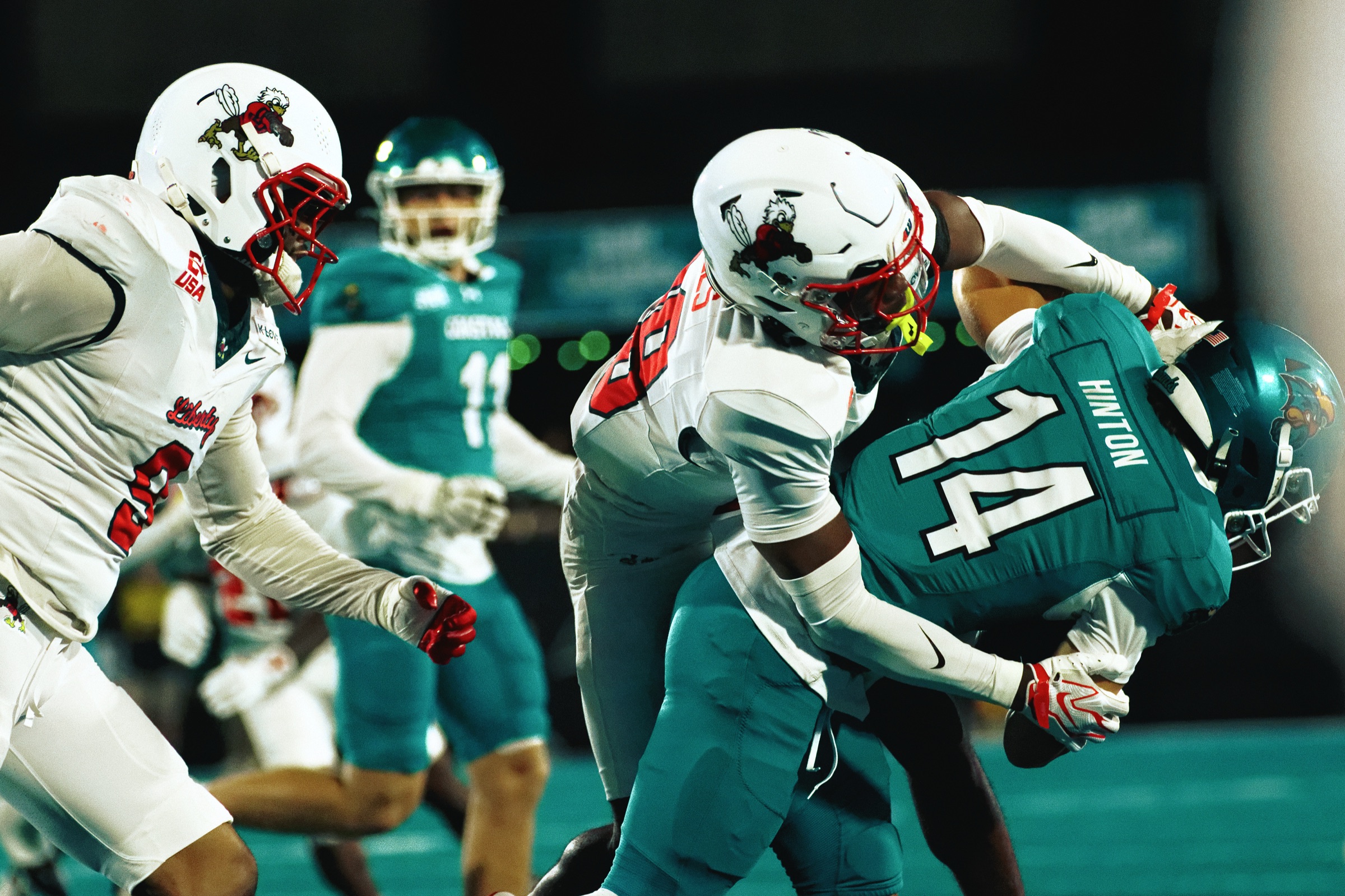 Liberty defenders tackle a Coastal Carolina ball carrier at Brooks Stadium on Sept. 24, 2026.