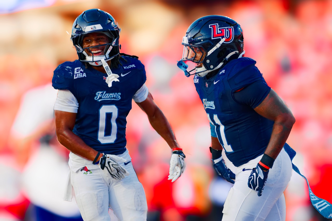 Liberty teammates share a moment during Saturday’s game at Williams Stadium.