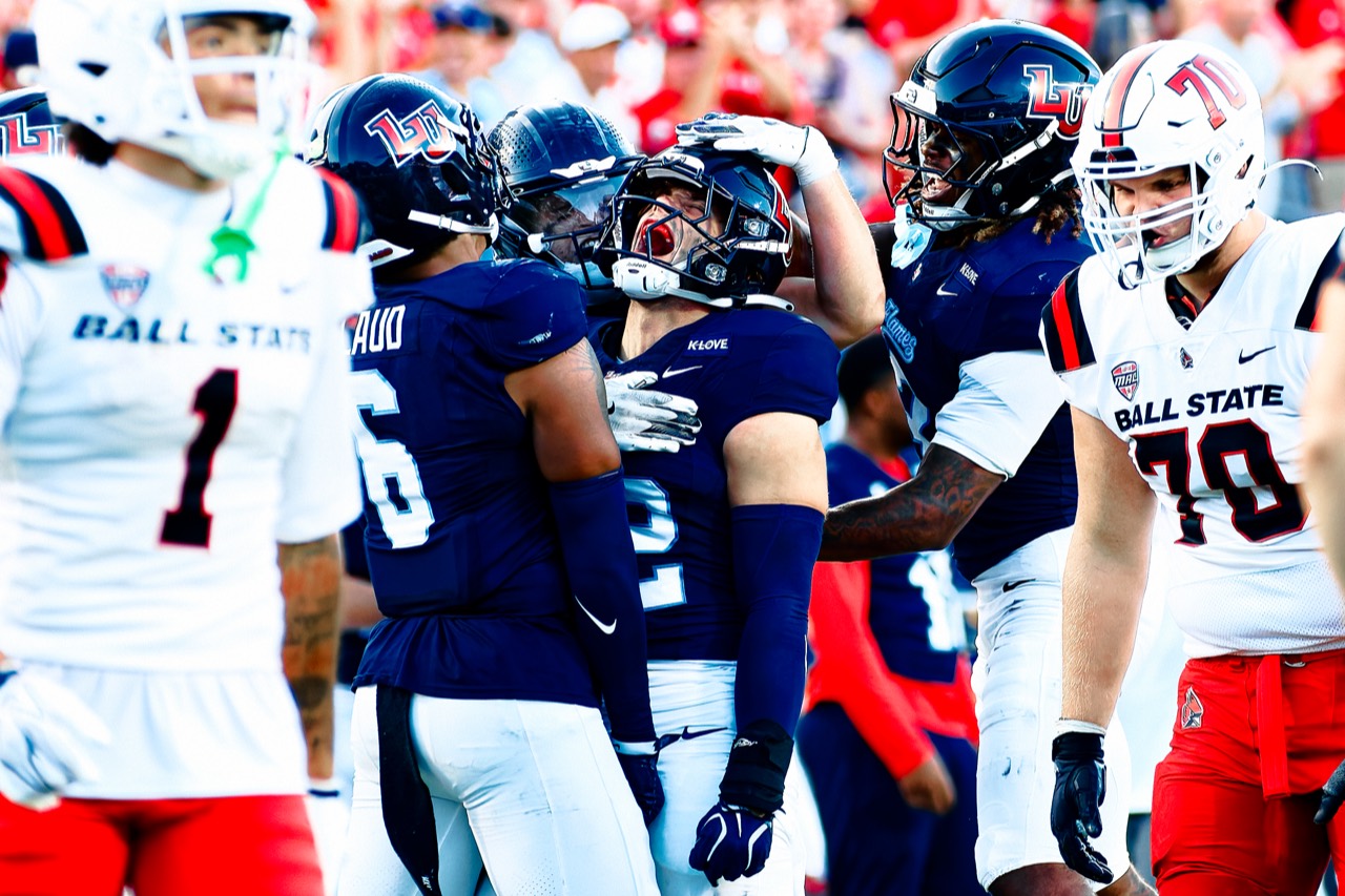 Liberty players gather during Saturday’s game against Ball State.