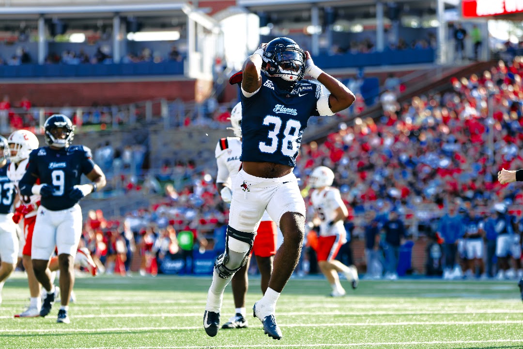 Liberty football player No. 36 rises above the field during a play