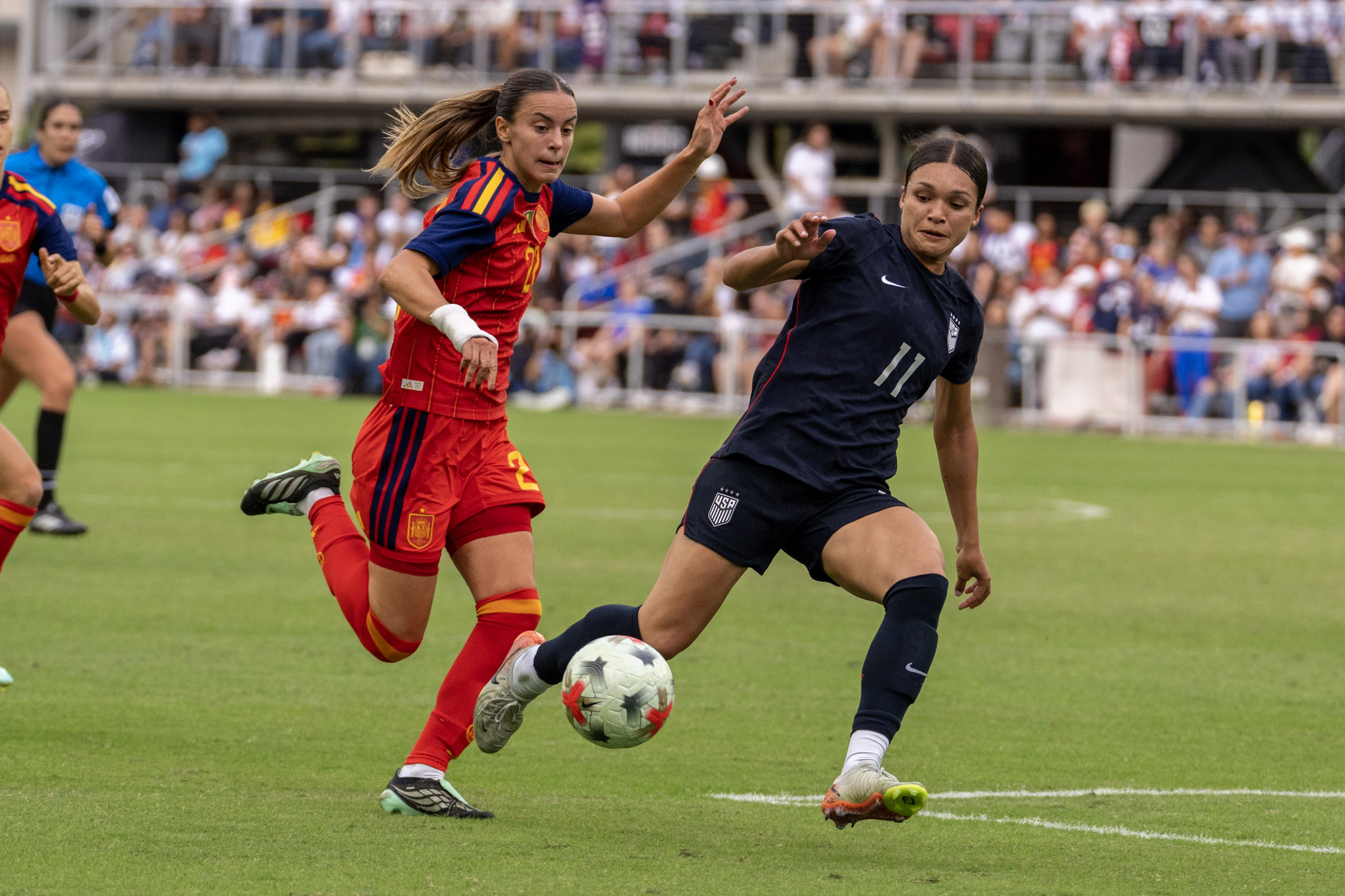 A U.S. player and a Spain player contest the ball at Audi Field on October 10.